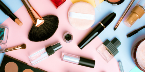 Cosmetics and brushes on a colorful table